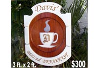 carved wood bed and breakfast sign