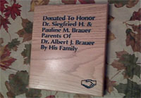 engraved wooden plaque with painted letters