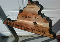 wood sign shaped in the state of the profile of state of virginia